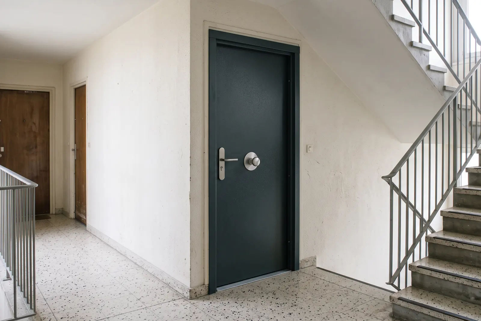 Porte blindée gris anthracite posée sur le palier d'une résidence à Sarcelles